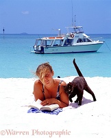 Jane on a white sand beach with cat