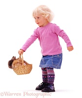 Little girl with rabbits in a basket