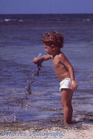Mark pouring mud on the beach, Jamaica 1968