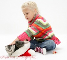 Girl with kittens in a Santa hat