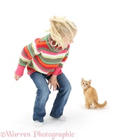 Girl scaring a ginger kitten