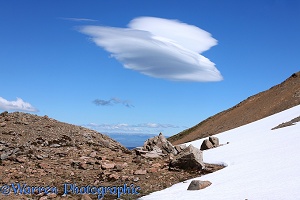 Rugged alpine landscape with lenticular cloud