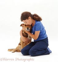 Girl cuddling a brown dog