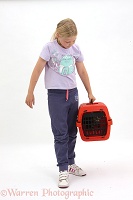 Girl with tabby kitten in a carrier