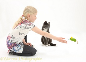 Girl throwing a toy mouse for a cat